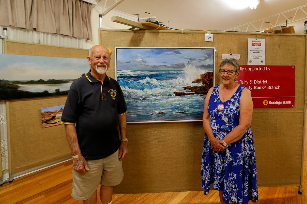 WINNER: Geoff Scott and Anne Fry from the Port Fairy Belfast Lions Club at the club's art show. They are standing in front of the best painting. Picture: Anthony Brady