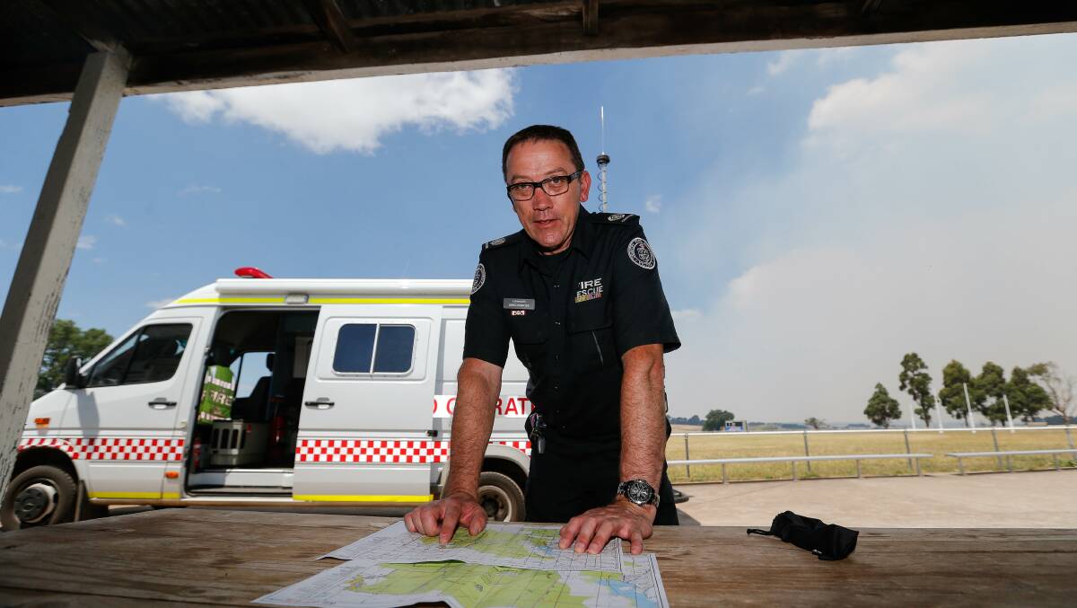 CFA commander Greg Kinross checks a map of the fire at Budj Bim National Park. Picture: Anthony Brady