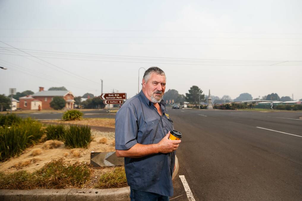 LONG NIGHT: Macarthur CFA volunteer Peter Nield drinking a coffee after working through the night on the fires. Picture: Anthony Brady
