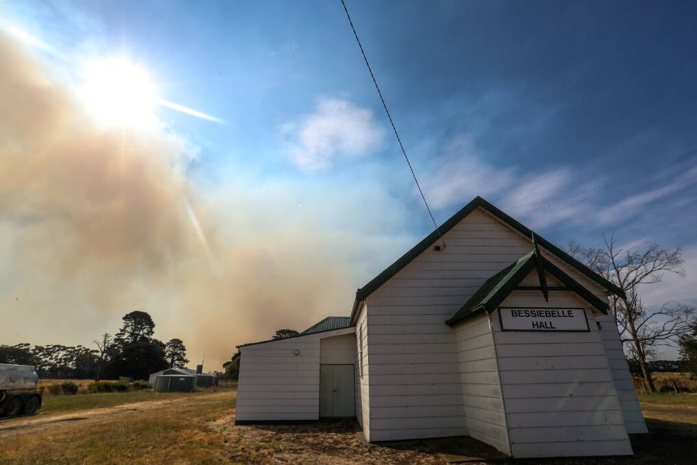 EVACUATION: Smoke billows from the Budj Bim bushfire behind the Bessiebelle Hall. The community was evacuated during as firefighters feared the blaze would not be controlled. Picture: Morgan Hancock