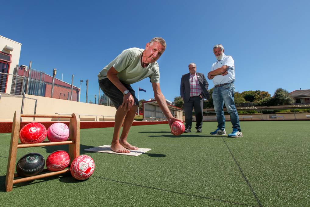 On A Roll: Anthony 'Parky' Parkinson gets his shoes off, with Warrnambool Bowls Club general manager Chris Bennett and bowls coordinator Paul O'Donnell watching.