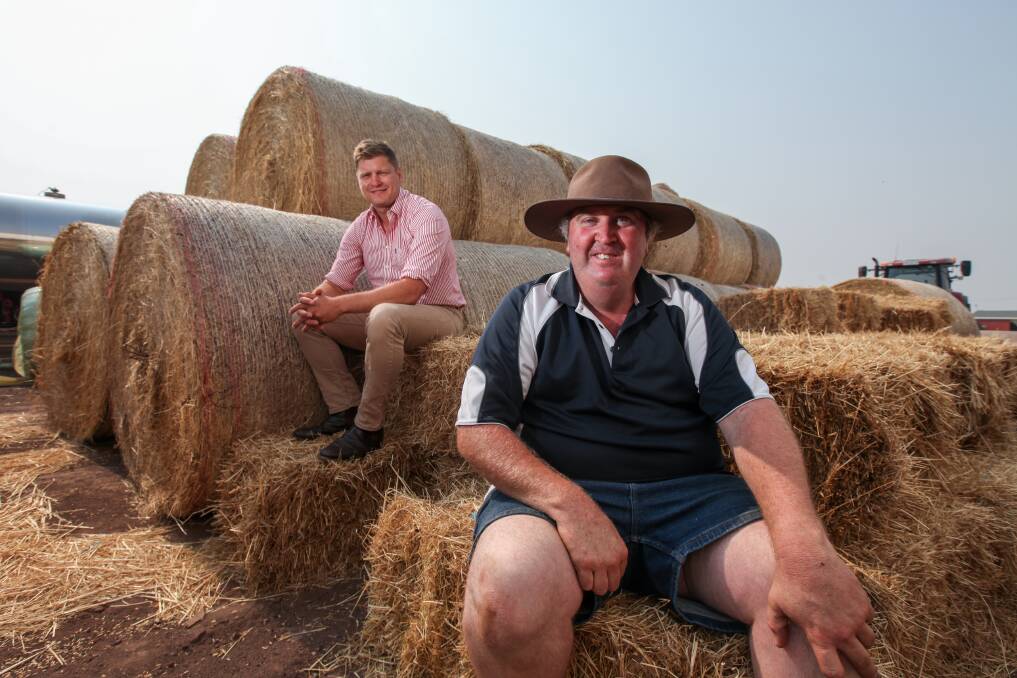 Helping out: Moyne Shire mayor Daniel Meade with hay run organiser Eddie White and some of the hay donated for East Gippsland. Picture: Rob Gunstone