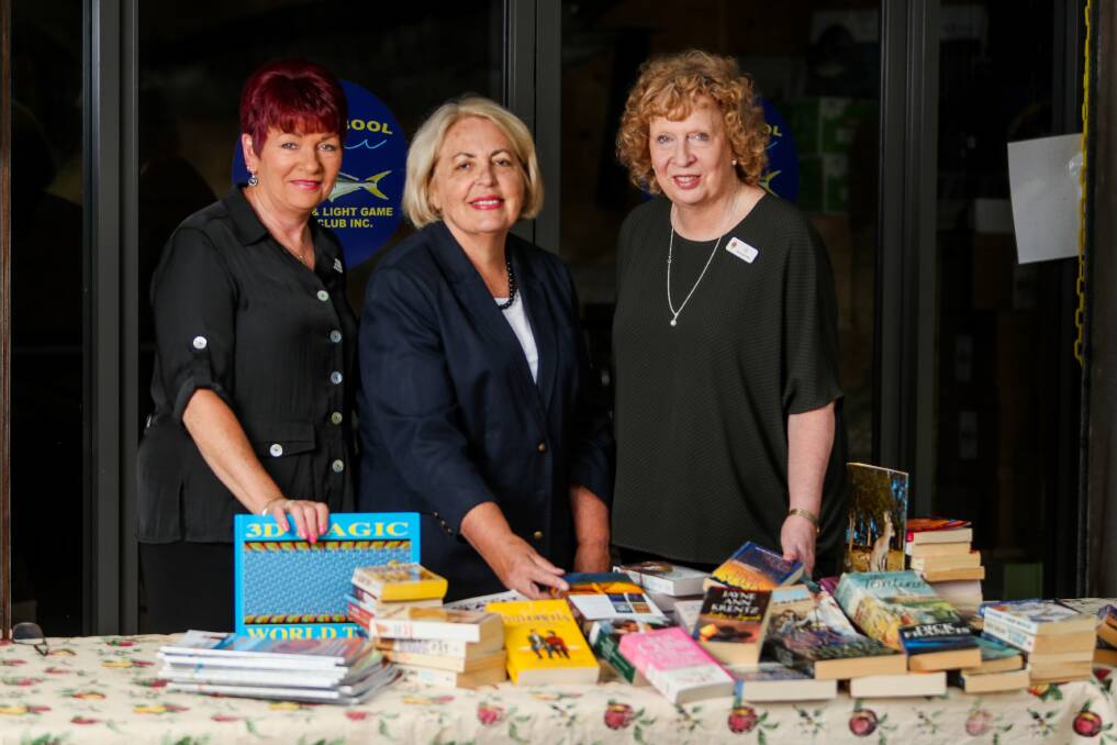 Books: Felicity Barker, Diana Young and chief executive Jo Bell with some of the books they will have on sale. Picture: Morgan Hancock