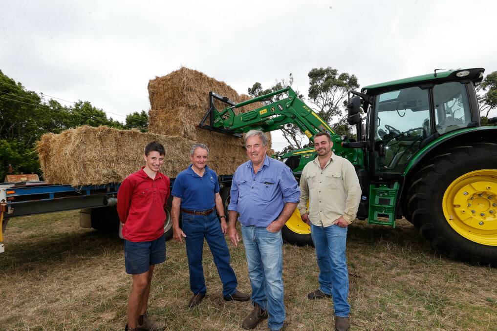 Donation: Ben Gilmour, Ray Smith, Max Anderson and Simon Anderson with hay the Timboon Lions Club are taking up to to drought and fire-affected Corryong in the Upper Murray. Picture: Anthony Brady