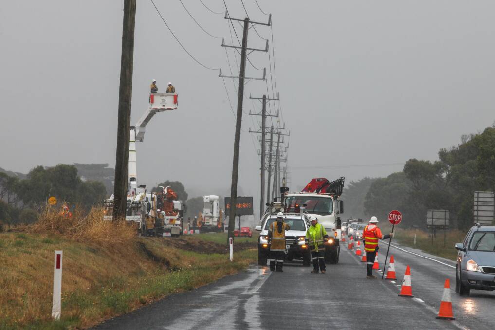 Repaired: Power company workers repair a power pole damaged in a fatal motor vehicle accident on Friday night on Princes Hwy near Jubilee Park Rd. Picture: Rob Gunstone