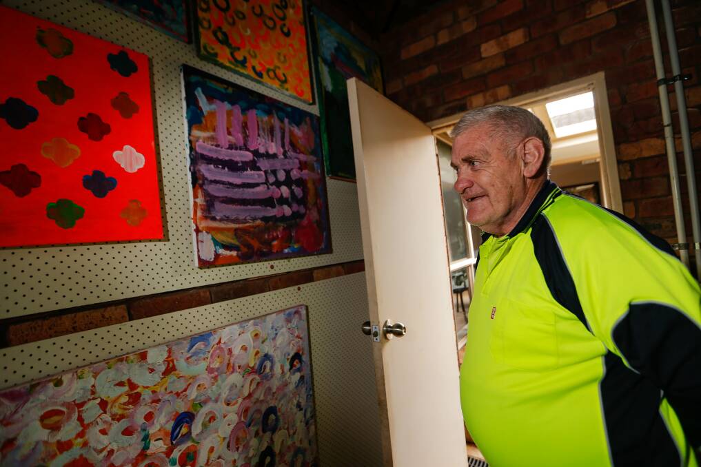 Neville O'Donohue admiring some of his artwork in his garage gallery. Picture: Anthony Brady