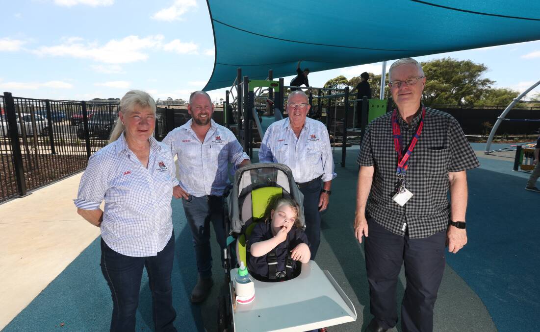 DELIGHTED: Koroit truck show secretary Julie Houlihan with committee members Richard Allen and Graeme Morris were delighted to hand over a cheque to Warrnambool Special Developmental School principal Robert Dowell and primary school student Grace Haberfield. Picture: Mark Witte