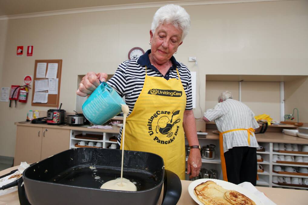 Production line: Uniting Church volunteer Helen van der Starre pours out another pancake during the Shrove Tuesday dinner. Picture: Rob Gunstone