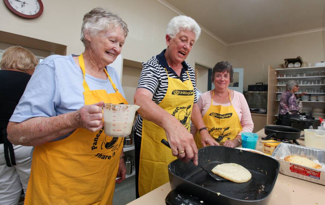 Flipping good time: Pancake Day coordinator Margaret McCosh keeps a close eye on quality with volunteers Helen van der Starre and Glenda Grayson. Picture: Rob Gunstone