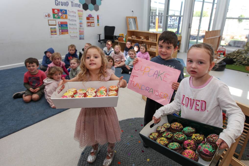Next Batch: Koala Kindergarten students Bella Rose Uhr, 4, Lucas Harrington, 4, and Marlee Moore get ready to deliver cupcakes to help raise money for animals injured in the recent bushfires. Picture: Rob Gunstone