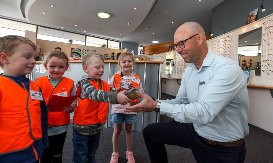 Treats delivered: Koala Kindergarten students Luke Obst, 4, Olivia Ross, 4, Joel Wallance, 5, and Frankie Bant, 4, deliver cupcakes to Luke Jephcott, practice manager at Penry Routson Optometrists. Picture: Rob Gunstone