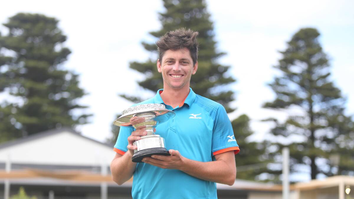 Third title: Andrew Whittington with the trophy after winning the men's open final. Picture: Mark Witte