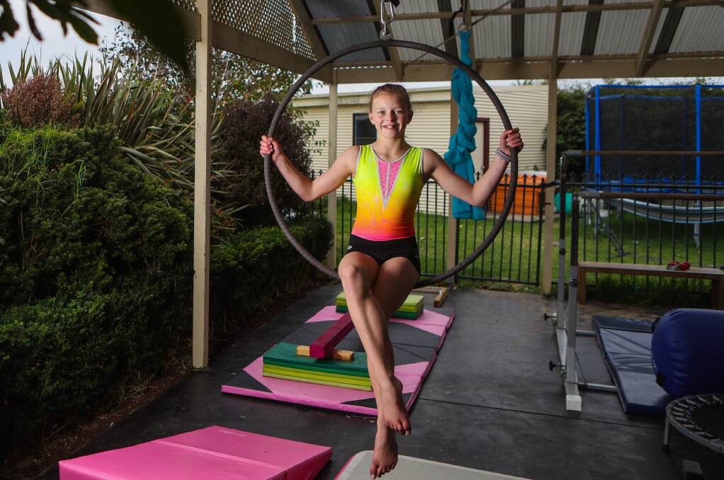 WORKING FROM HOME: Chloe Mutton has been training for gymnastics and aerials in her backyard. Picture: Morgan Hancock