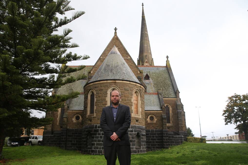 Historical: Terang Presbyterian Church pastor Damian Meeuwissen stands in front of the building which became a hospital during the Spanish flu pandemic. Picture: Mark Witte