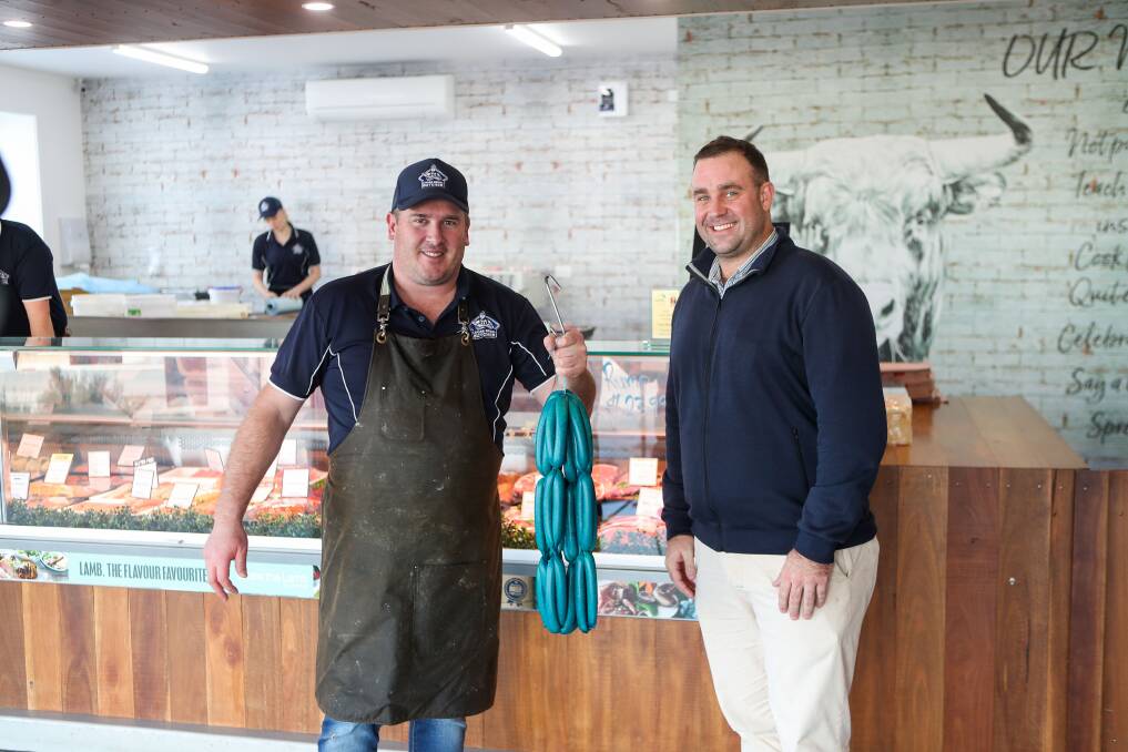 Raising awareness: Lucas Bros Butcher are making blue sausages to mark May 8 and Do it for Dolly Day, raising awareness for mental health, Peter Harris shows off the sausages alongside MatchWorks' Pete McEwen. Picture: Morgan Hancock