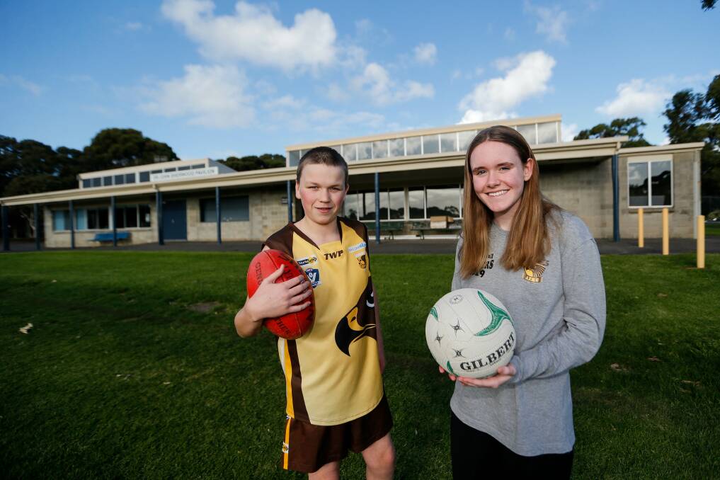 READY TO PLAY: Hawks players Kelby Fleming, 13, and Emma McLaren, 15, will get to play football and netball respectively in 2020. Picture: Anthony Brady