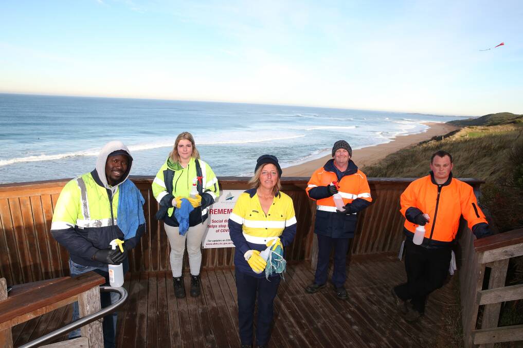 All ready: Cleanaway members M0 Kamara, Tamika Ledner, Melissa Taylor, Lindsay Glossop and Don Glossop at the Logans Beach whale watching platform. Picture: Mark Witte