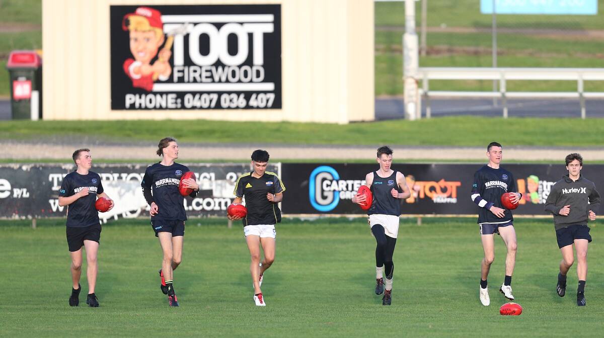 IN IT TOGETHER: Warrnambool under 16 players warm up before training at Reid Oval on Wednesday. Picture: Mark Witte