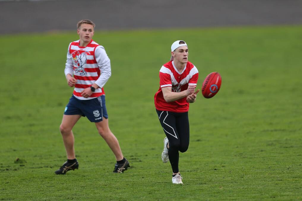PREPARATION: South Warrnambool's Willem O'Sullivan (front) goes to handball during an under 18 training session on Wednesday. Picture: Mark Witte