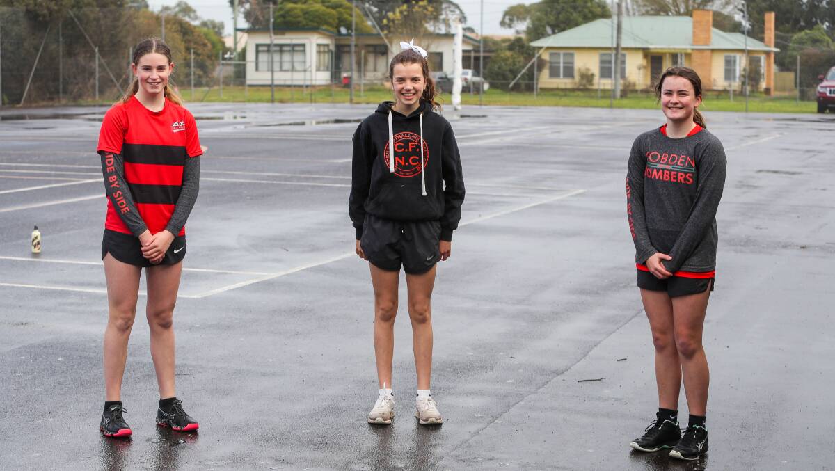 SEE THE BOMBERS FLY UP: Eisha Howard, Kate Smith and Jess Walsh pose for a photo at Cobden training. Picture: Morgan Hancock