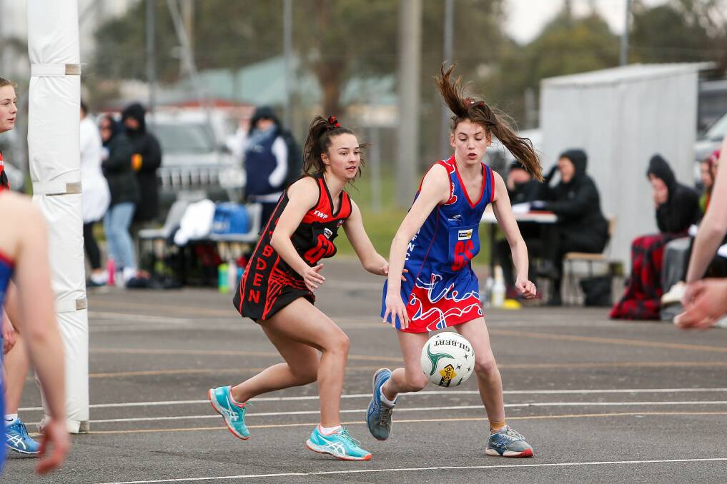 BATTLING FOR POSSESSION: Cobden's Emily Darcy and Terang Mortlake's Alice Kain eye the ball during their 15 and under netball game. Picture: Anthony Brady