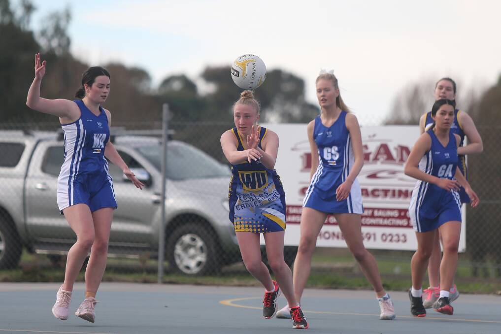 BACK ON COURT: North Warrnambool Eagles' Sarah Bryne looks to pass the ball against Hamilton Kangaroos in 17 and under netball last week. Picture: Mark Witte