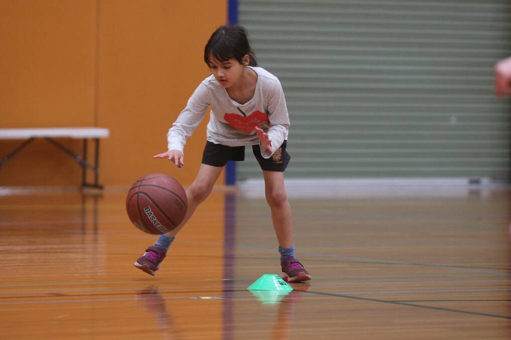 Concentrating: Warrnambool's Anika Flynn, 9, dribbles the ball at under 12 girls training on Monday. Picture: Mark Witte