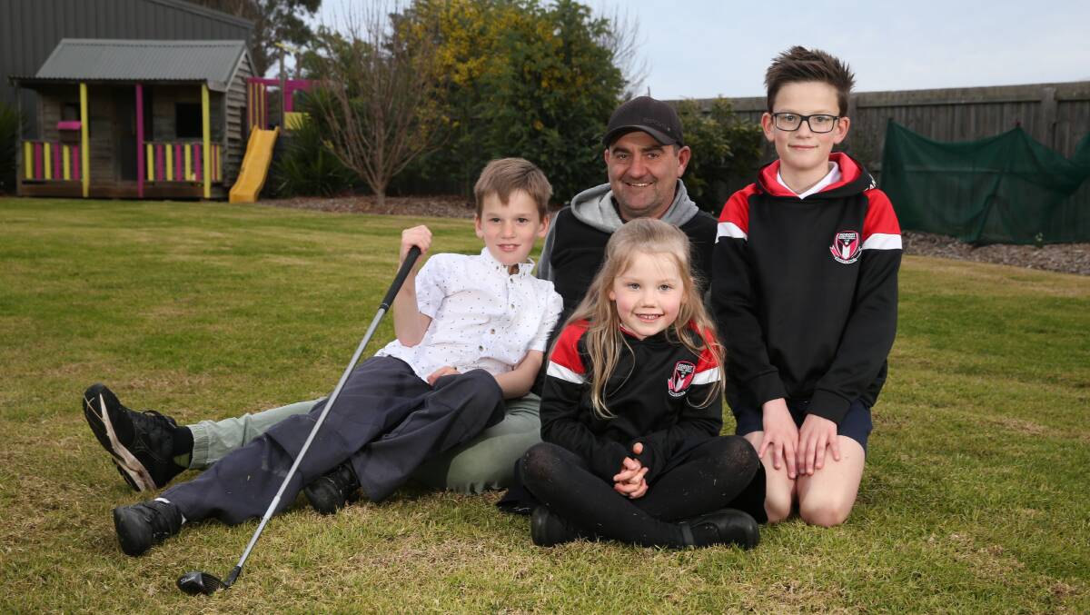 ACE: Koroit's Chris Keane with children Byron, 8, Freya, 6, and Jai, 10. Picture: Mark Witte