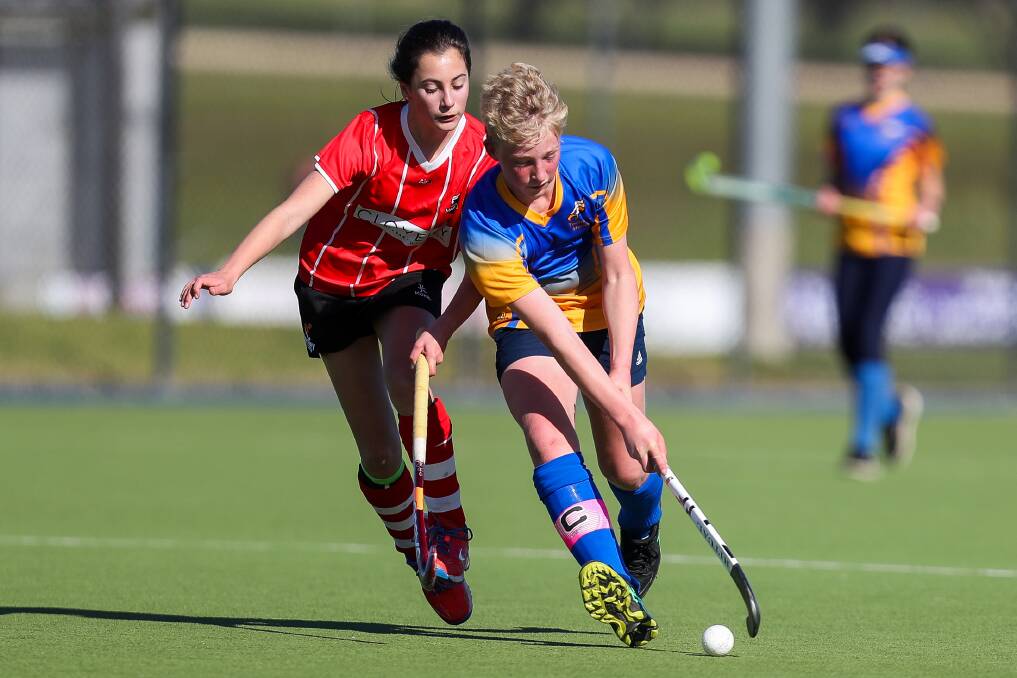 COMING BACK: Techtonics' Harry Dodson moves the ball past Buccaneers' Anne Davis during a game earlier this year. Picture: Morgan Hancock