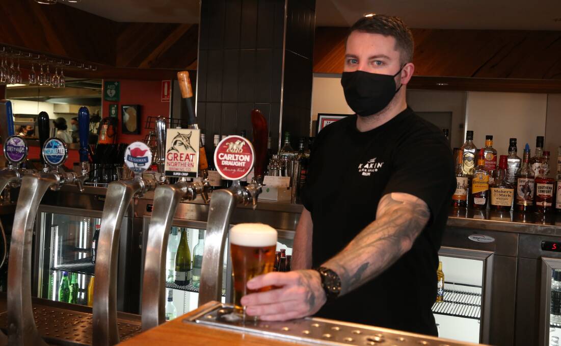 On tap: Bartender Dylan Barling serves a beer on Wednesday at Flying Horse Bar and Brewery. Picture: Mark Witte