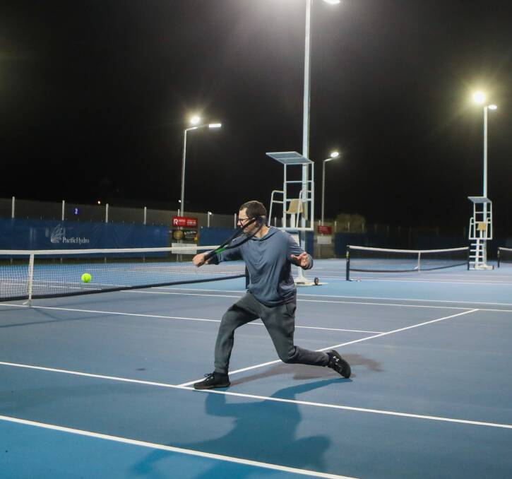 Bright: Nigel Harper plays under the Port Fairy Tennis Club's new lights. Picture: Morgan Hancock