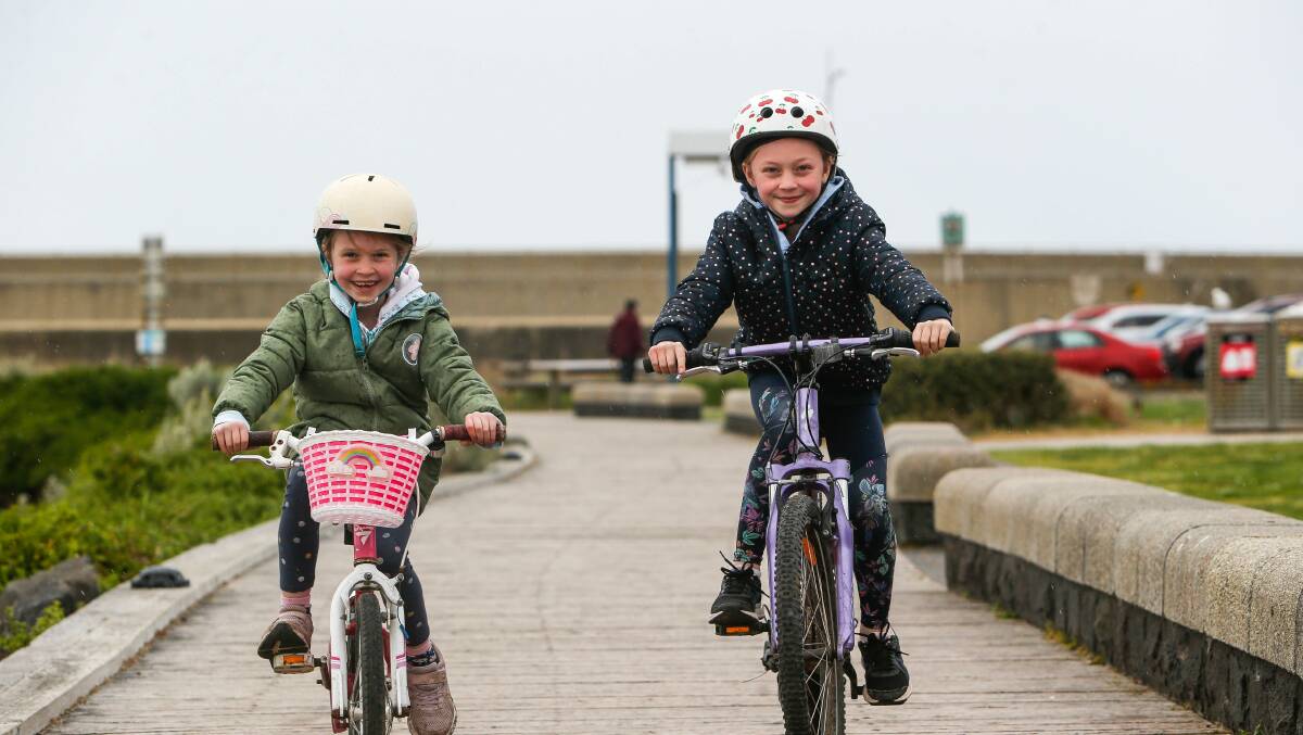 All smiles: St Thomas' Primary students Isabel Moloney, 7, and Tiah Moloney, 9, are participating in a region-wide virtual duathlon. Picture: Anthony Brady