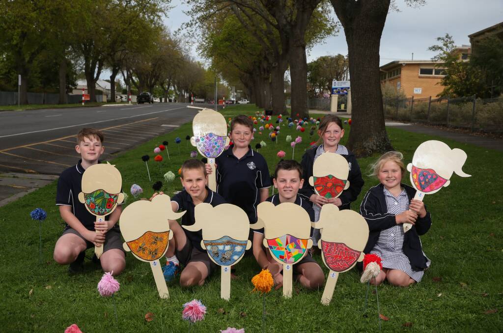 Camperdown College students Leon Ahearn, 11, Nate Castle, 10, Bayleigh Newcombe, 11, Fletcher Tolland, 11, Charlie Burnett, 10, and Chloe Castle, 8, have designed masks to go on the wooden heads. Picture: Mark Witte