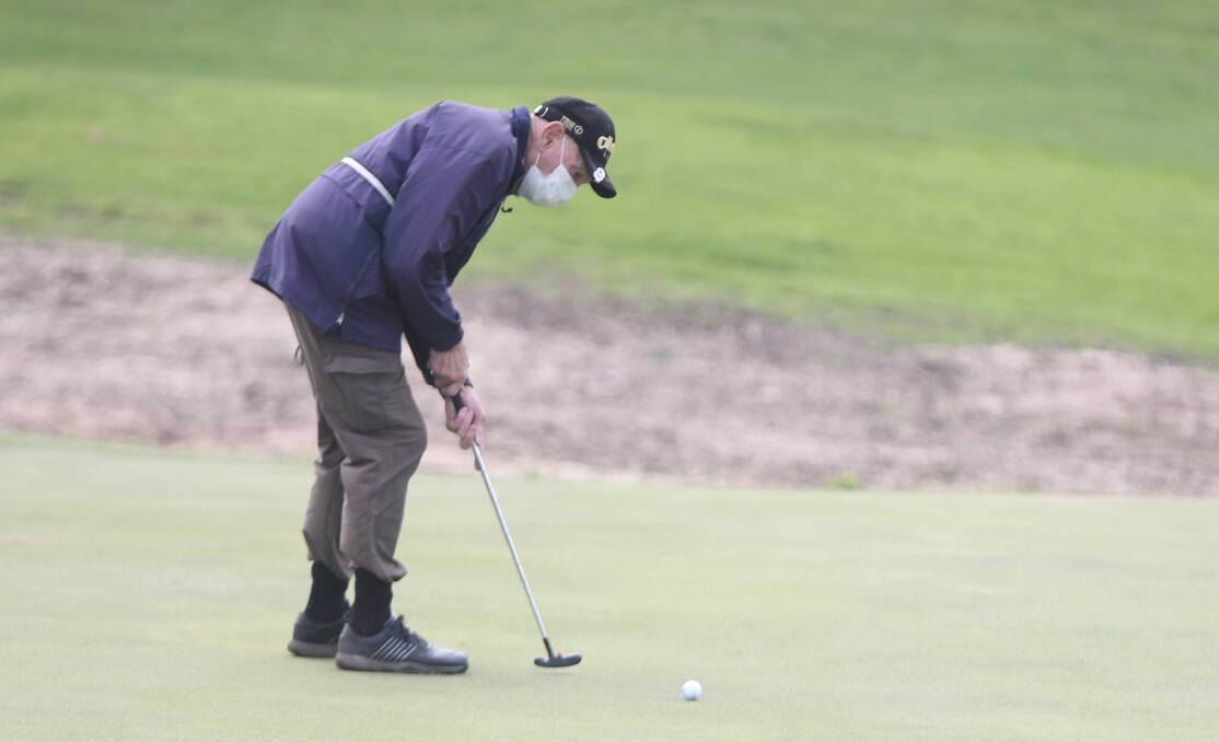 Rolling along: Warrnambool's Alan Grigson putts on the 18th green. Picture: Mark Witte