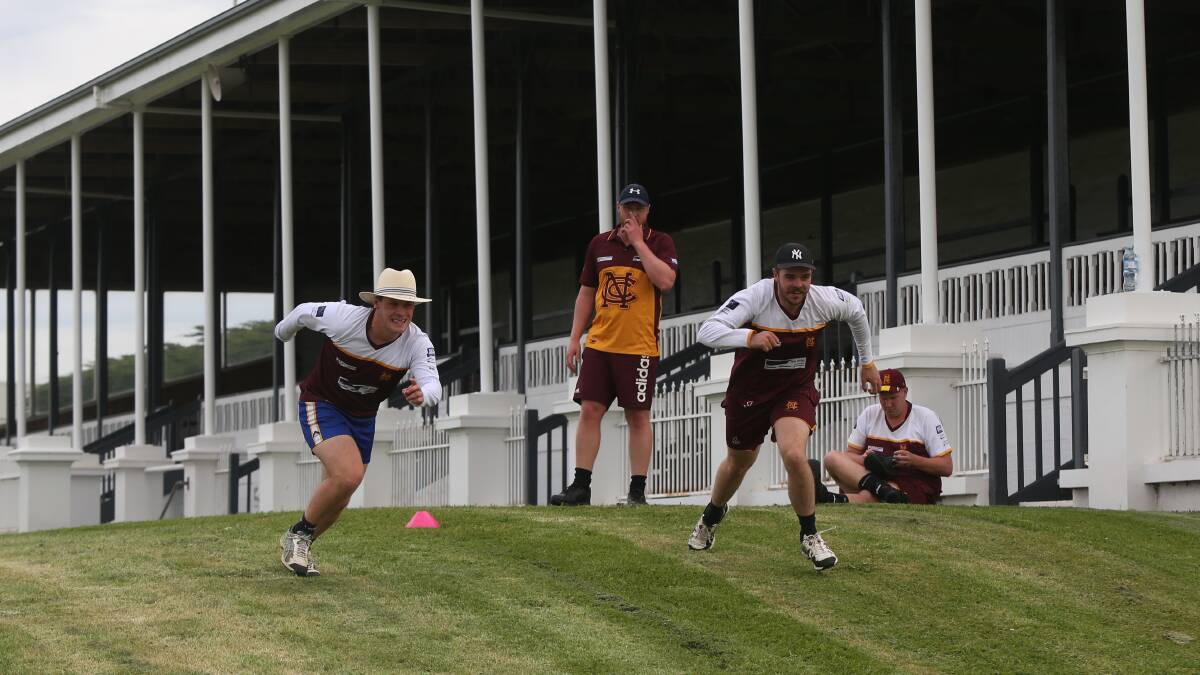 Nestles players Jacob Pope and Ryan Hetherington do hill runs in front of the stands at the Warrnambool Racing Club. Picture: Mark Witte
