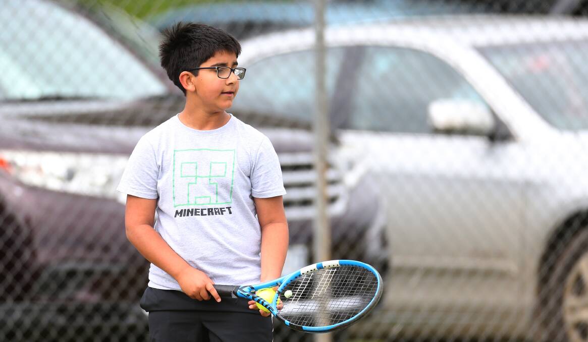 Playing tennis again: Warrnambool's Ashaan Davis, 10, serves during Warrnambool Lawn Tennis Club's junior pennant on Saturday. Picture: Mark Witte