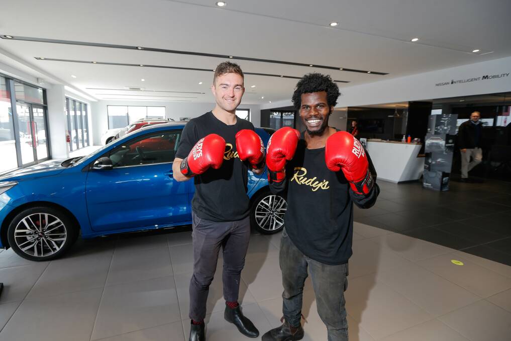 BIT OF FUN: Workmates Ben Turner-Dwyer and Brian Agina will turn Warrnambool Nissan and Kia's showroom into a boxing ring this weekend. Picture: Anthony Brady