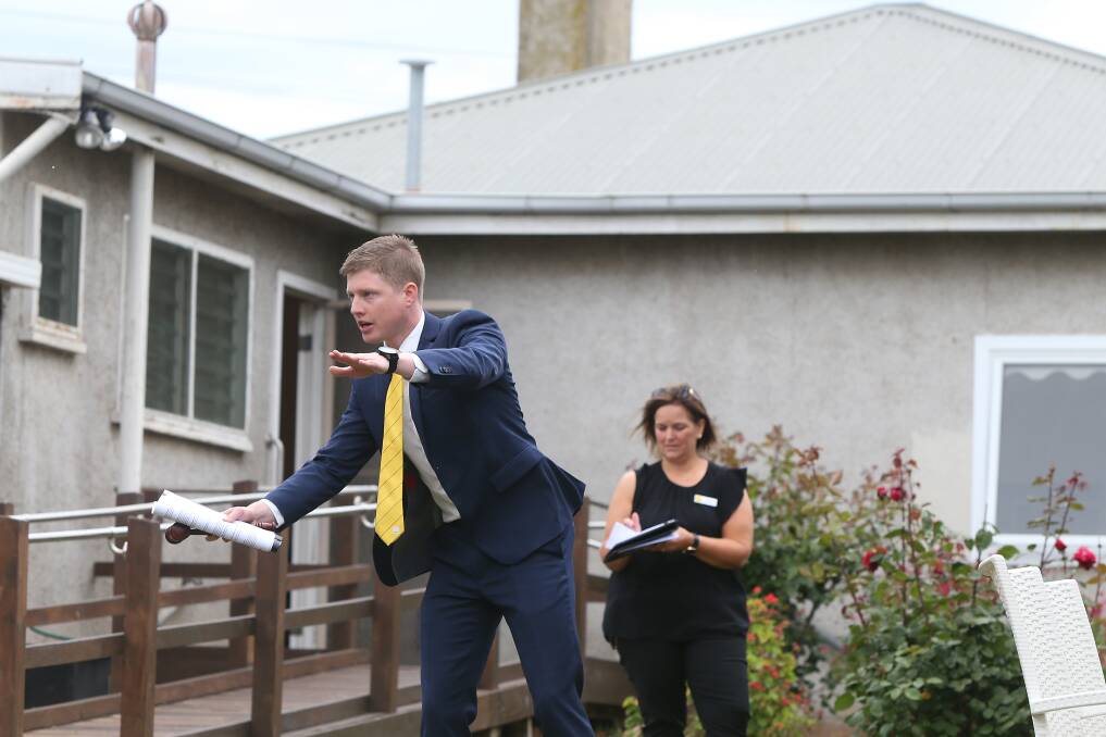 Ray White's Fergus Torpy in action during the auction at a Banyan Street property. Picture: Mark Witte