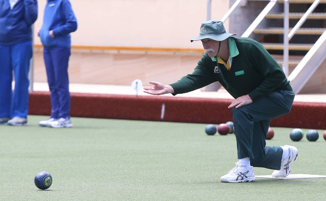 LETTING IT GO: Terang Gold's Greame Downie gets one rolling at Warrnambool Bowls Club on Tuesday. Picture: Mark Witte