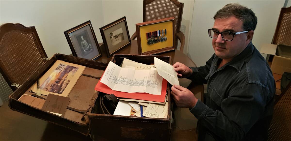 History: Graeme Cox with a suitcase of his grandfather Jack Cox's memorabilia.