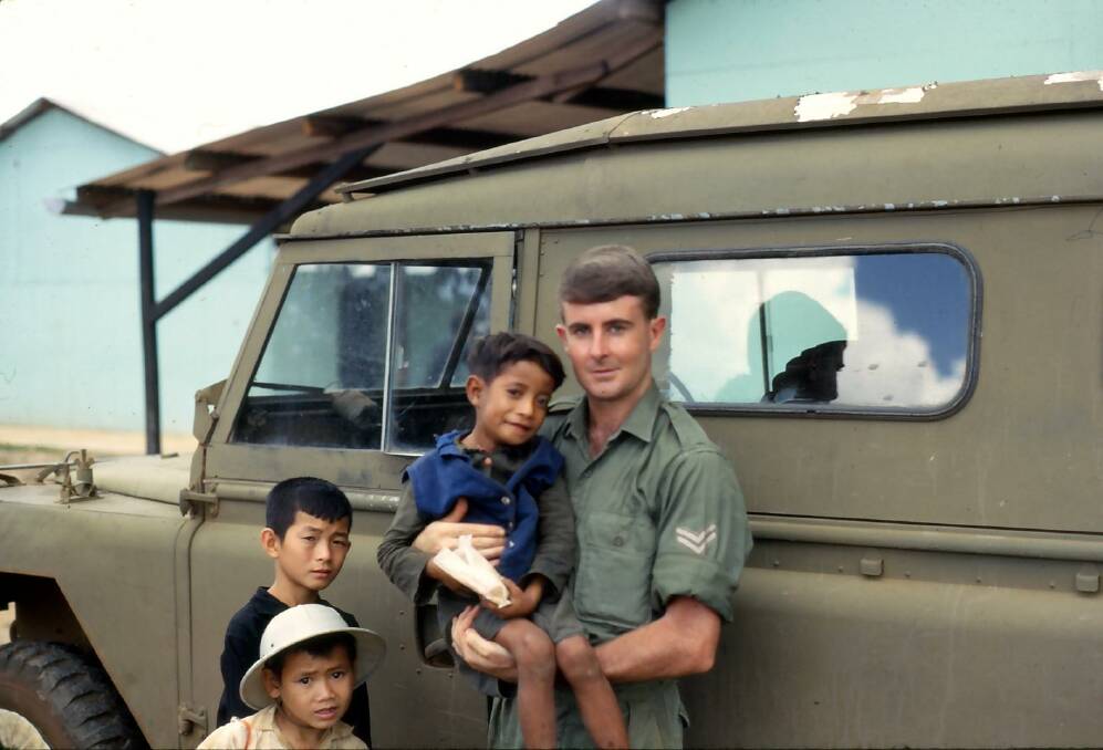 Ken Cumming holds a Vietnamese boy nicknamed Rabbit who he befriended during the war. He has now reconnected with him 55 years later. Picture supplied