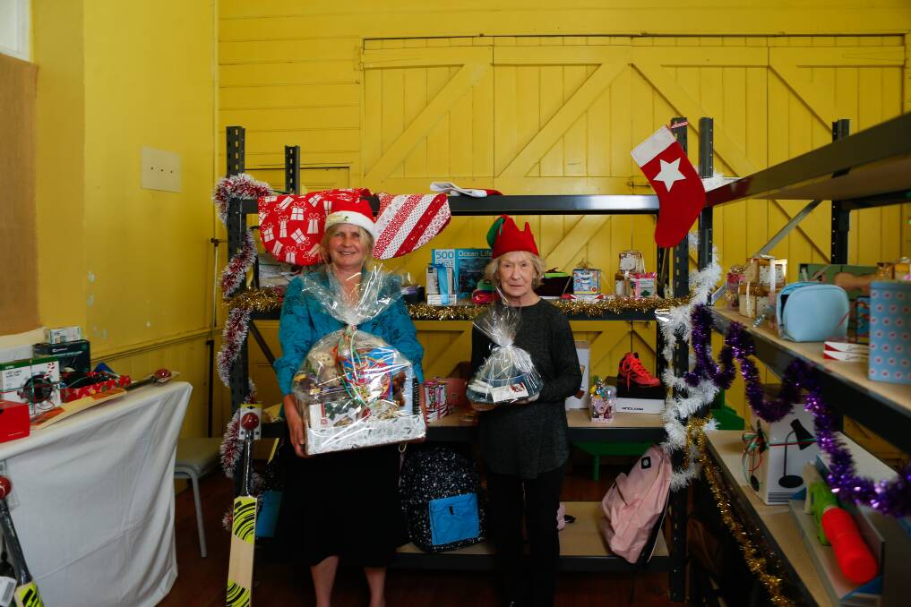 Helping hands: Anglicare's Louise Serra and Pat Saunders with some of the gifts people who have accessed its services can select. Picture: Emma Stapleton