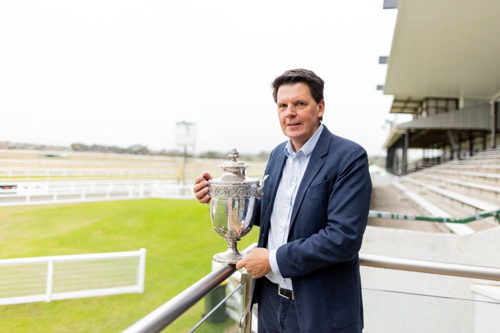 Warrnambool Racing Club chairman Mark McNamara with the impressive 1929 Lindsay Cup. It is part of the club's extensive memorabilia collection. Picture by Anthony Brady