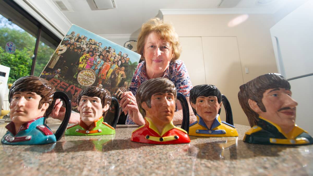 Sandra Smith with Sgt. Pepper's Lonely Hearts Club Band and Royal Doulton mugs, including a second special edition John Lennon mug (centre). Picture: Karleen Minney
