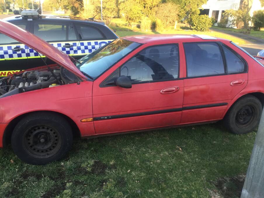 The faded red Ford Falcon sedan seen driving dangerously on the Princes Highway.