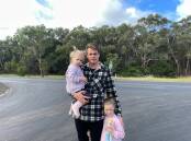 Sam Lange with daughters Gigi, 2, and Freddie, 5, at the notorious intersection of Cobden-Warrnambool Road and Rollos Road. Picture by Jessica Howard
