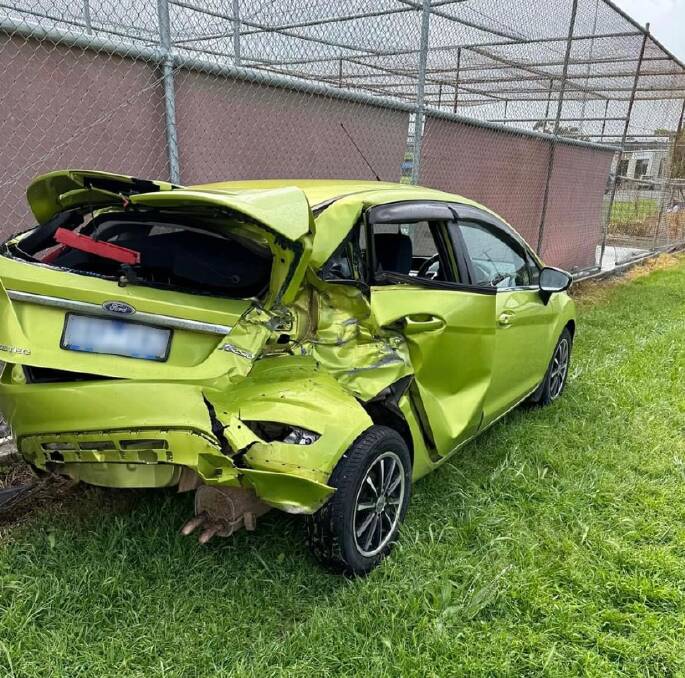 The damaged green vehicle. 