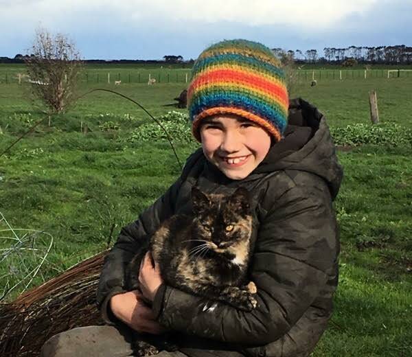 TEARS OF JOY: Ian McGillivery, 9, with his cat Pam, who survived the St Patrick's Day fires. Picture: Supplied 
