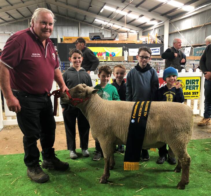 DOMINATED: Grassmere's Barry Shalders and his grandchildren pictured with his interbreed award winning South Suffolk Ram at the Warrnambool Show sheep competition. Picture: Supplied