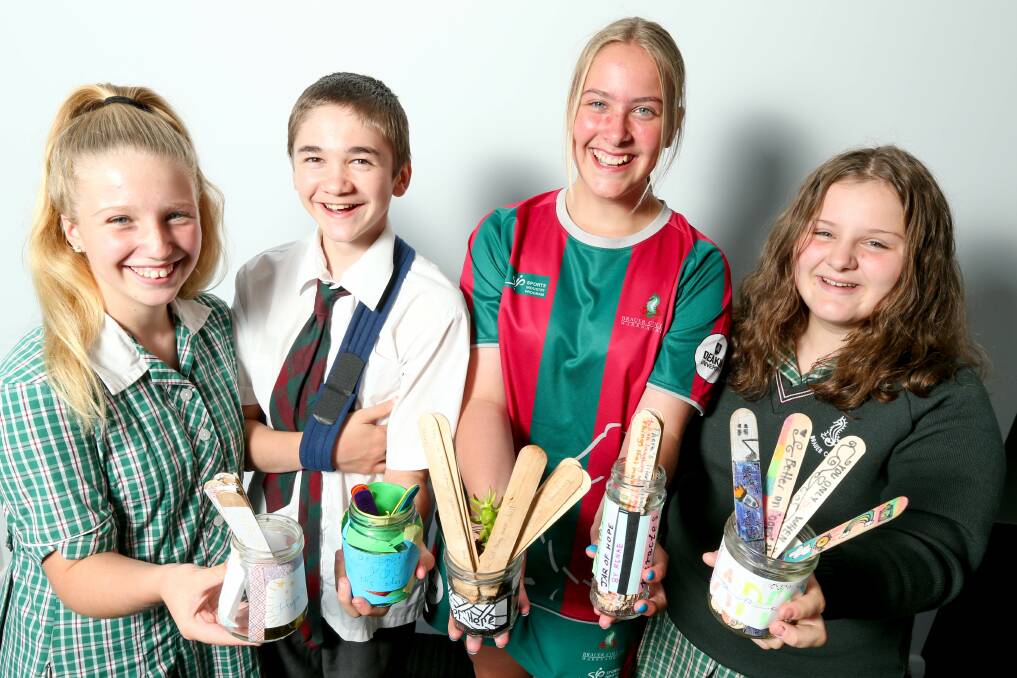 PROUD: Brauer College year eight students Renae Mauriks, Jenna Umney, Zoran Hunter and Caitlin Smith show off their Jars of Hope. Picture: Christopher Doheny 